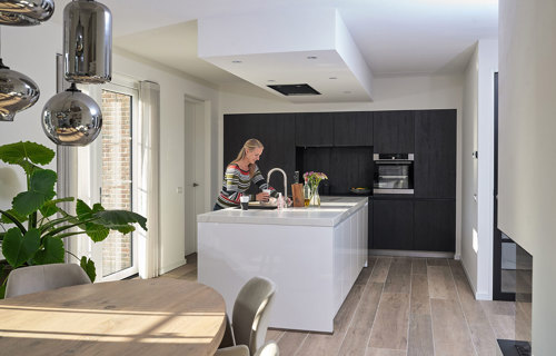 Witte eilandkeuken met zwarte kastenwand