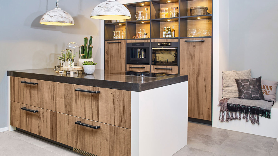 Landelijke keuken met eiland en kastenwand. In industriële stijl en voorzien van luxe apparatuur.